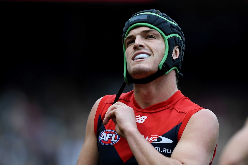 Angus Brayshaw holds a strap on his headgear.