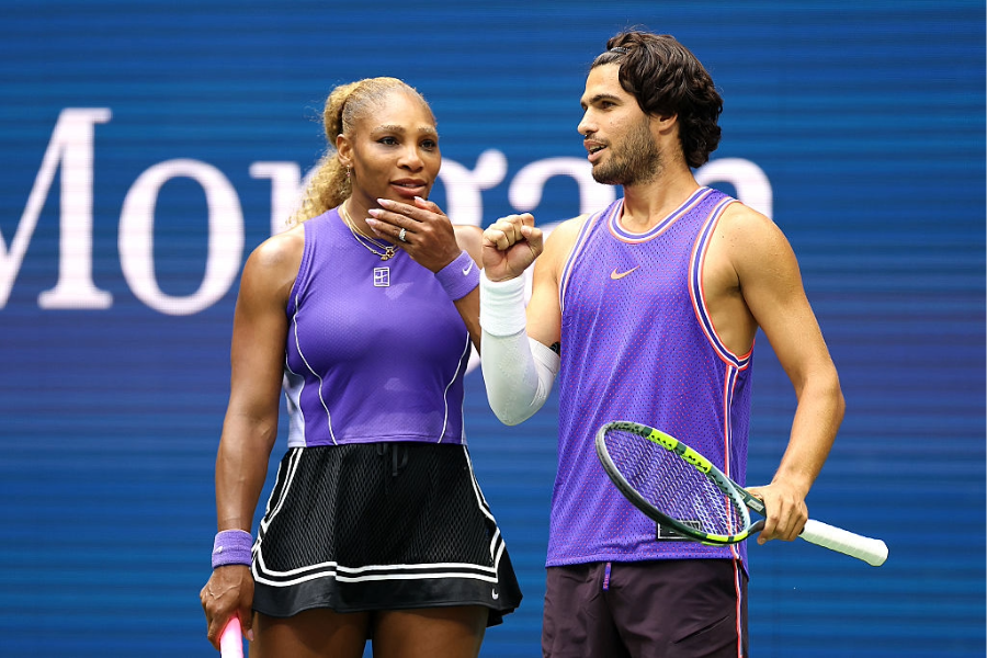 NEW YORK, NEW YORK - AUGUST 25: Carlos Alcaraz of Spain interacts with Serena Williams of the United States in their mixed doubles match against Erin Routliffe of New Zealand and Lloyd Glasspool of the United Kingdom during Fan Week at the USTA Billie Jean King National Tennis Center on August 25, 2026 in the Flushing neighborhood of the Queens borough of New York City. (Photo by Sarah Stier/Getty Images)