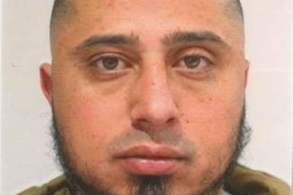 Bilal Haouchar with beard, beige jacket