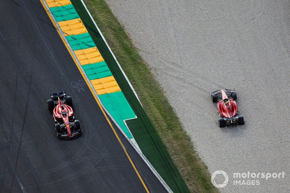 Charles Leclerc, Ferrari F1-75, passes the beached car of Carlos Sainz, Ferrari F1-75