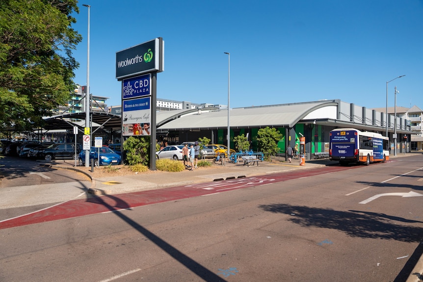 A bus stop is located outside a Woolworths in the Darwin CBD.