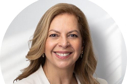 Office-style headshot of a woman with brown hair.