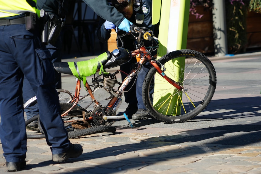 A mangled motorised push-bike, with a brown children's cap