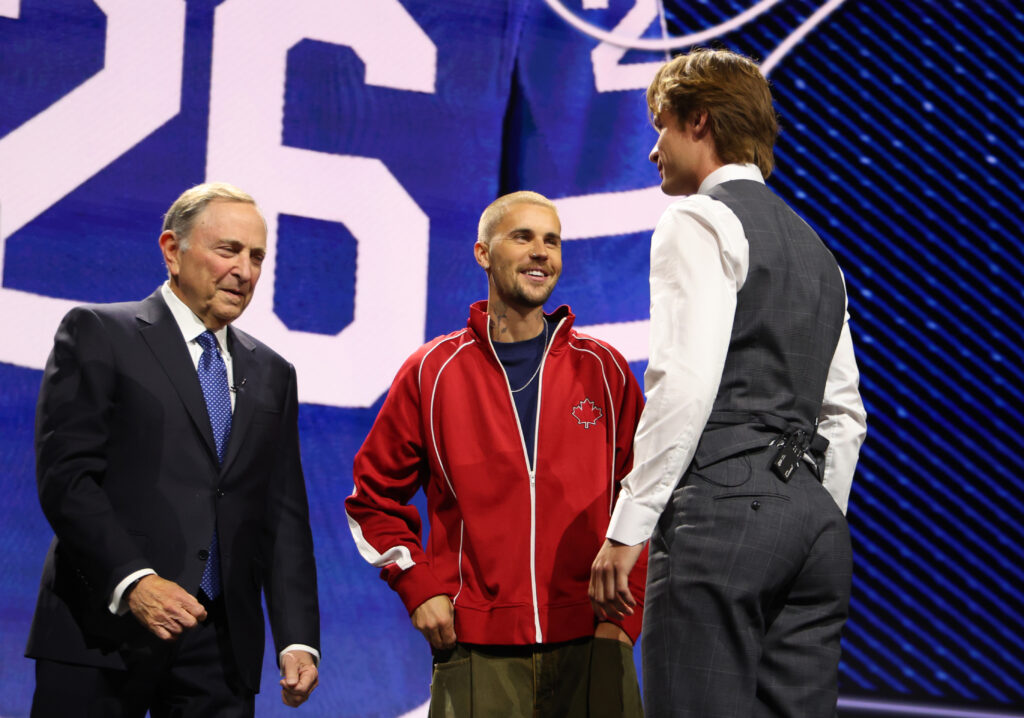 Gavin McKenna talks to NHL commissioner Gary Bettman and singer Justin Bieber