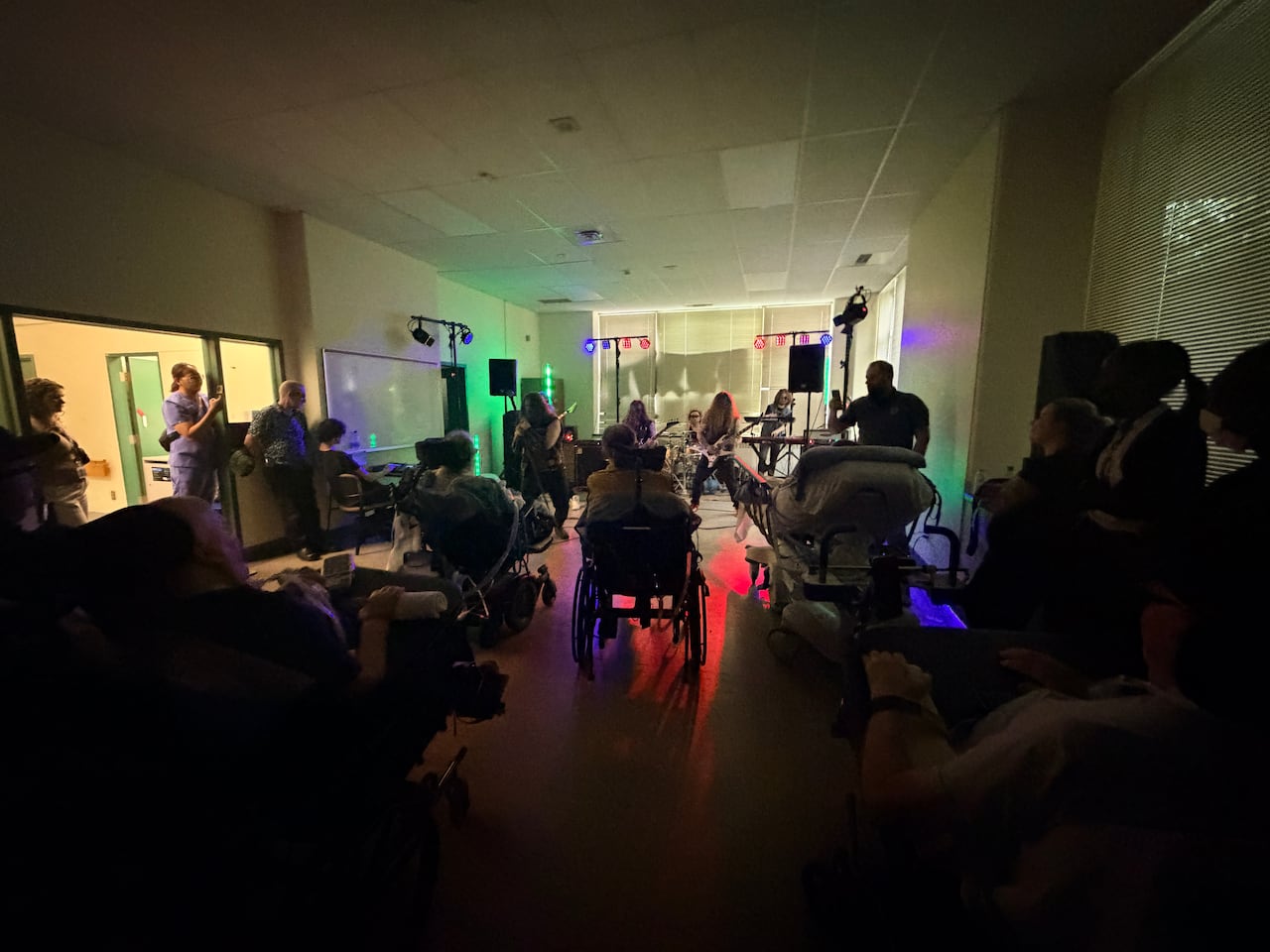 A band performs while patients at a hospital look on.