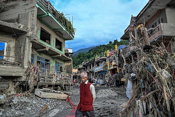 Buildings are damaged and partially buried in mud and debris in the Devighat area of the Nuwakot district in Nepal.