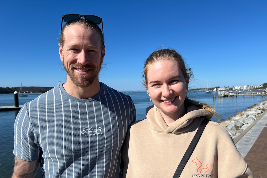 Fraser and Ward-Brown stand on a sunny bayside footpath.