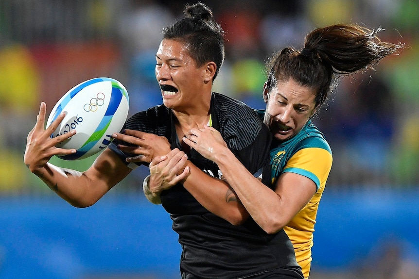 An Australian player tackling a New Zealand opponent in the 2016 Olympic women's rugby sevens final.