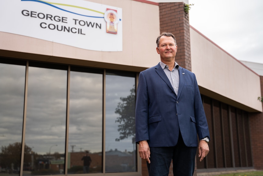 Greg Kieser standing in front of a building which says 'George Town council'.
