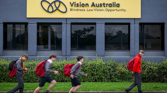 Scotch College students head home past the Vision Australia head office.
