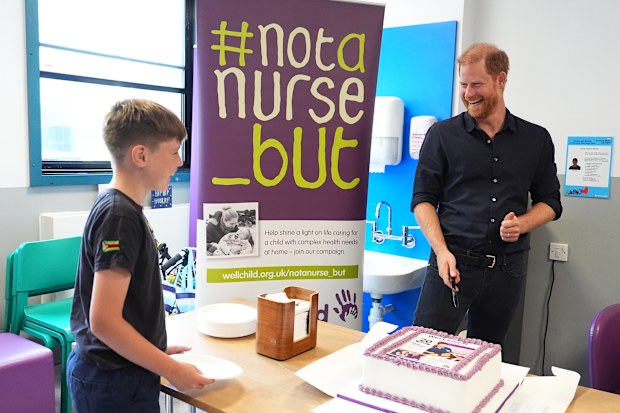 Prince Harry, Duke of Sussex, Patron of WellChild, cuts a cake with 12-year-old patient Wyatt Makwana celebrating 20 years of the WellChild programme, during a visit to the Birmingham Children’s Hospital to celebrate the 20th anniversary of the very first WellChild Nurse on July 9, 2026 in Birmingham, England.