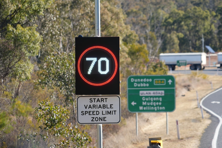 A flashing sign with the number 70 in a red circle.