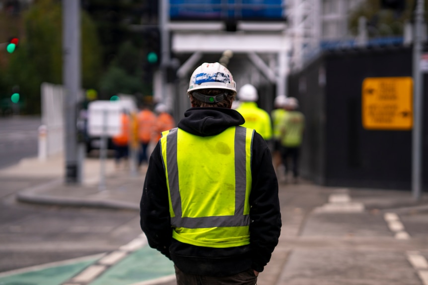 Construction worker wearing fluro vest and hard hat