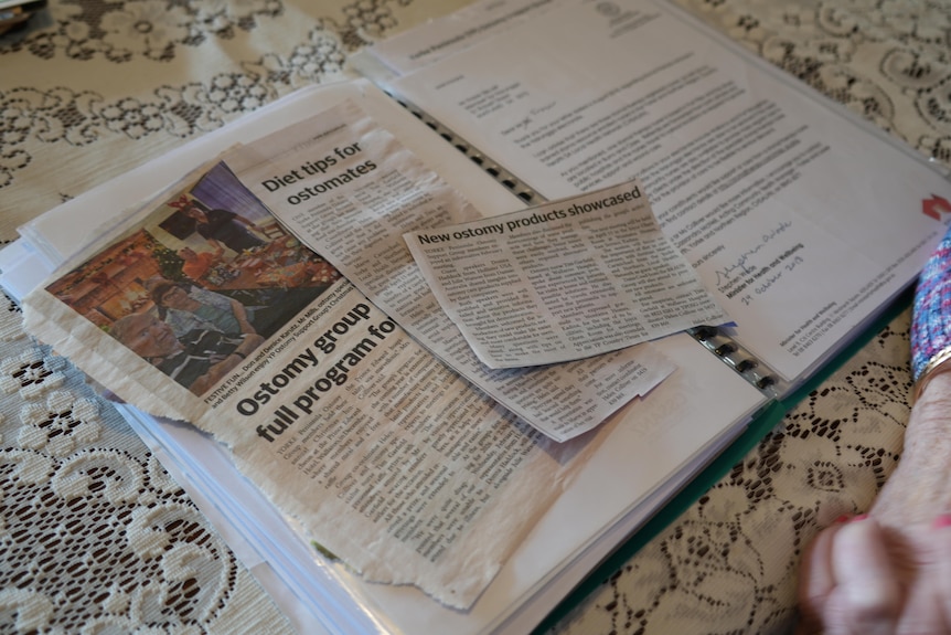 Newspaper clippings sitting on a table depicting news stories on stoma support.