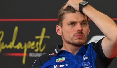 Verstappen on FIA sofa in Red Bull kit looking stressed with hand running through hair