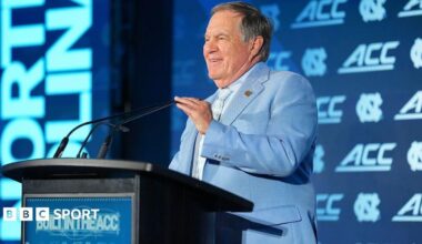 Bill Belichick speaking at a podium before the start of the US College season