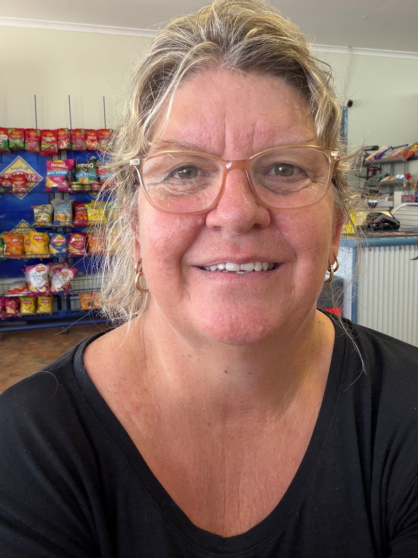 woman with blond hair and glasses