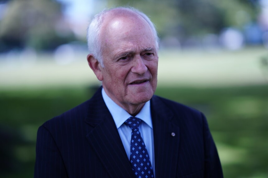 Peter Wertheim wearing a suit and tie and blazer