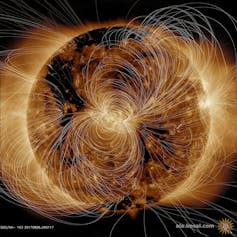 An image of a giant sphere with curving and messy white lines going around it in various directions.
