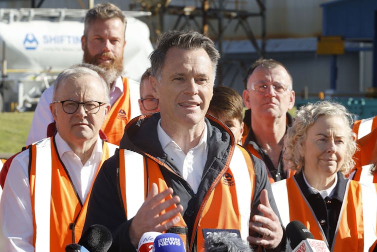 New South Wales Premier Chris Minns speaks to media, Prime Minister Anthony Albanese is standing in background