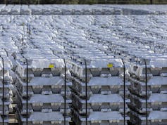Stacked piles of aluminium stored outdoors
