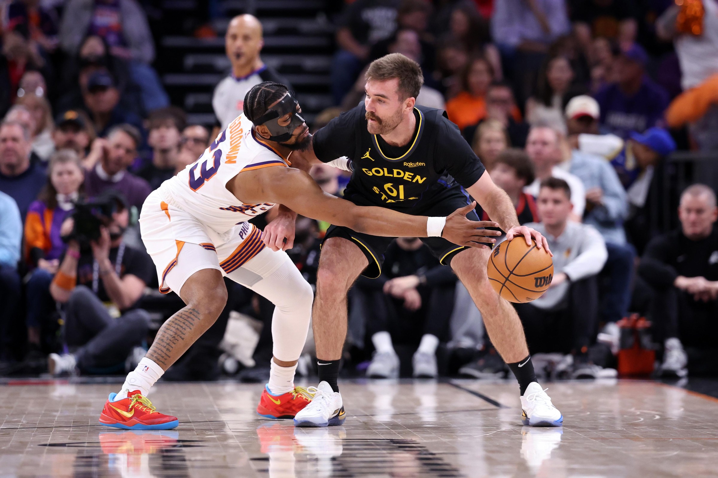 PHOENIX, ARIZONA - FEBRUARY 05: Jordan Goodwin #23 of the Phoenix Suns pressures Pat Spencer #61 of the Golden State Warriors during the first half at Mortgage Matchup Center on February 05, 2026 in Phoenix, Arizona. NOTE TO USER: User expressly acknowledges and agrees that, by downloading and or using this photograph, User is consenting to the terms and conditions of the Getty Images License Agreement. (Photo by Chris Coduto/Getty Images)