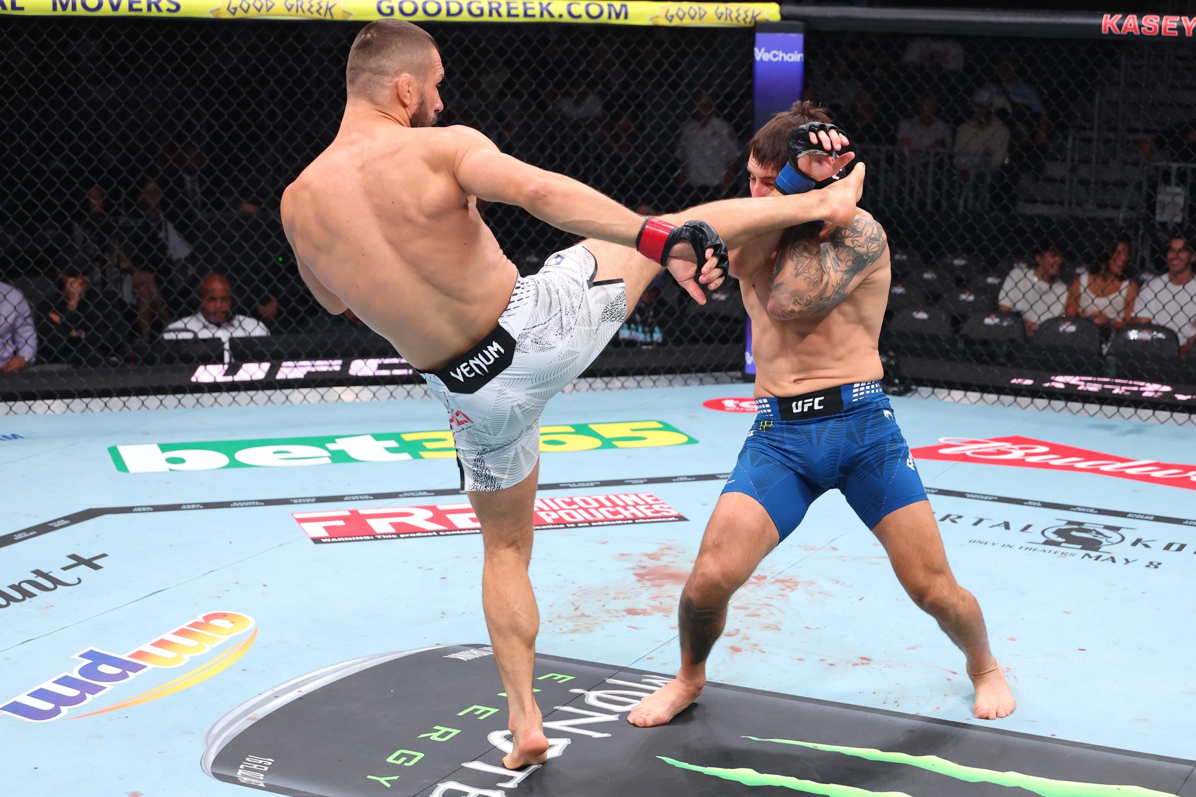 MIAMI, FLORIDA - APRIL 11: (L-R) Mateusz Gamrot of Poland kicks Esteban Ribovics of Argentina in a lightweight fight during the UFC 327 event at Kaseya Center on April 11, 2026 in Miami, Florida. (Photo by Ed Mulholland/Zuffa LLC)