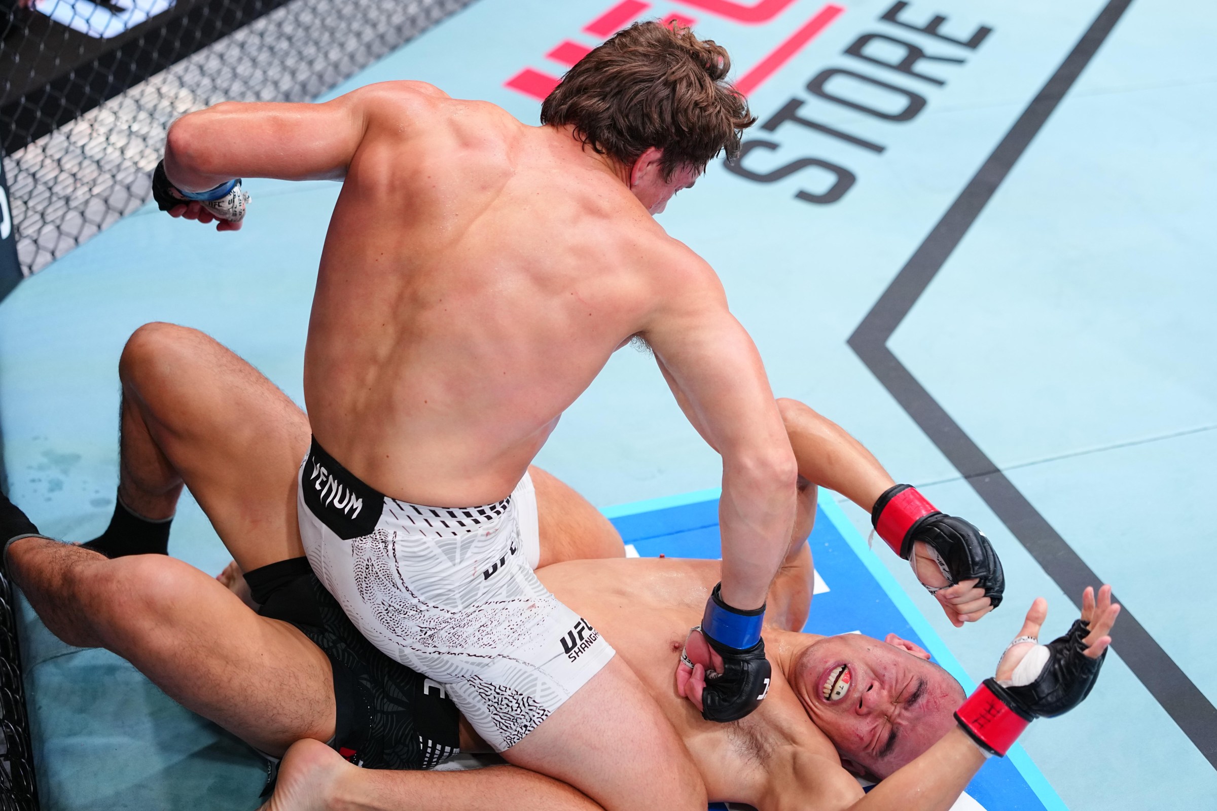 SHANGHAI, CHINA - AUGUST 29: Cam Nelson of Canada punches Ding Meng of China in a welterweight fight during the UFC Fight Night event at SPD Bank Oriental Sports Center on August 29, 2026 in Shanghai, China. (Photo by Chris Unger/Zuffa LLC)