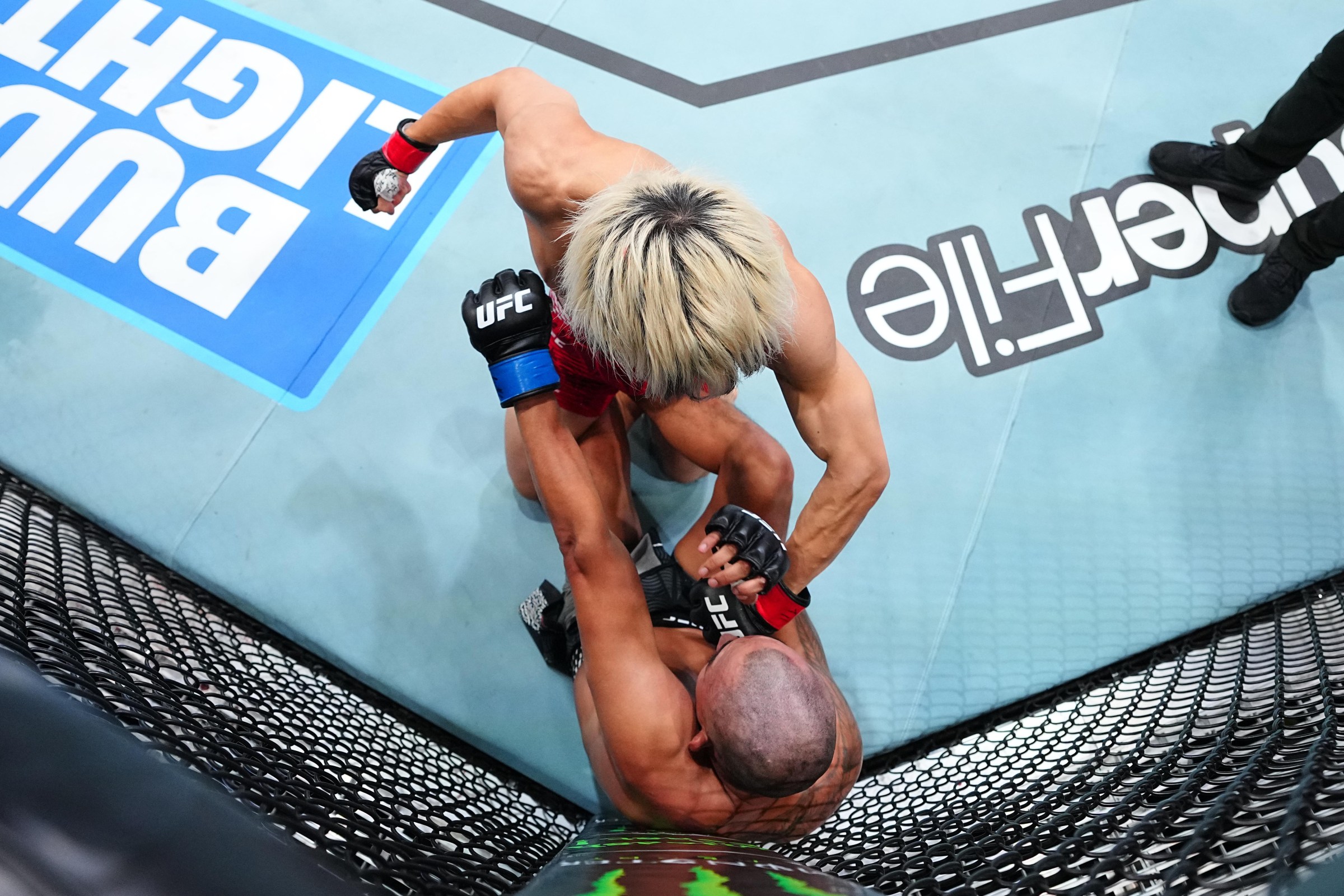 SHANGHAI, CHINA - AUGUST 29: Rei Tsuruya of Japan punches Kevin Borjas of Peru in a flyweight fight during the UFC Fight Night event at SPD Bank Oriental Sports Center on August 29, 2026 in Shanghai, China. (Photo by Chris Unger/Zuffa LLC)