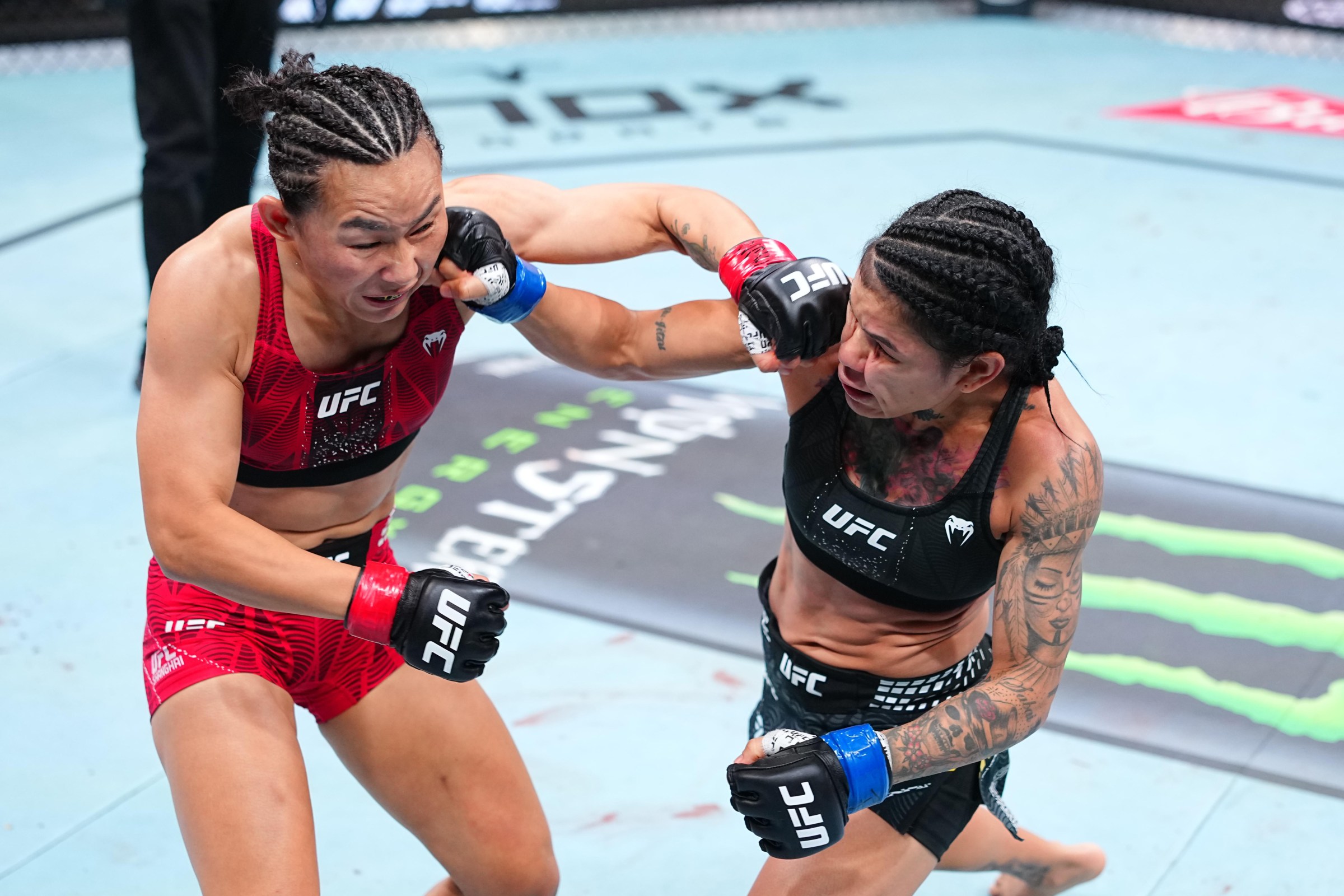 SHANGHAI, CHINA - AUGUST 29: (R-L) Denise Gomes of Brazil and Yan Xiaonan of China trade punches in a strawweight fight during the UFC Fight Night event at SPD Bank Oriental Sports Center on August 29, 2026 in Shanghai, China. (Photo by Chris Unger/Zuffa LLC)
