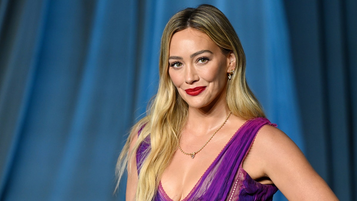 Hilary Duff posing on a red carpet at the Academy Museum Gala.