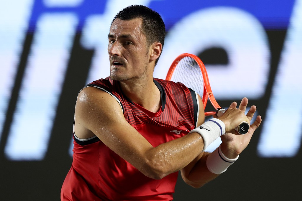 Bernard Tomic of Australia returns a shot to Cameron Norrie of Great Britain during the Mifel Tennis Open.