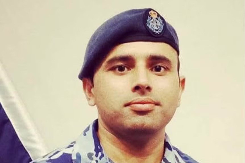A man in his RAAF uniform including a sloped cap, looking directly at camera.
