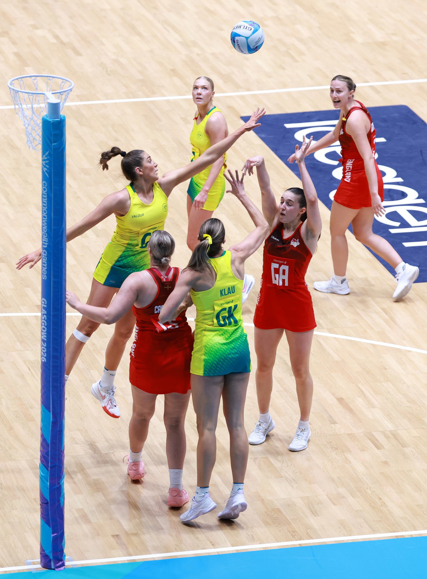 A netball player shooting a goal.