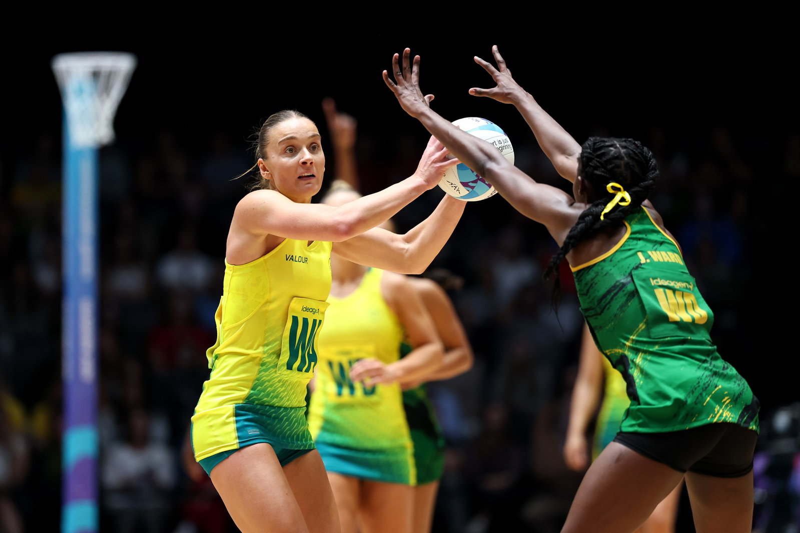 A netball player is about to throw a pass.