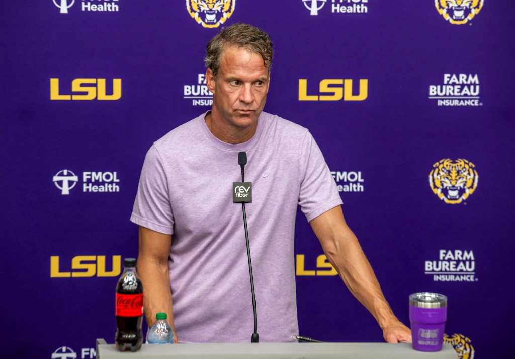LSU head coach Lane Kiffin fields questions at a press conference.