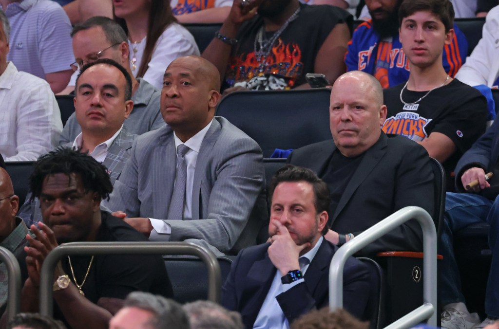 Gersson Rosas, William Wesley, and Leon Rose sitting courtside at a Knicks game.