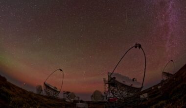 The LST-1 and MAGIC telescopes on La Palma stand in the darkness beneath a clear, star-studded night sky.