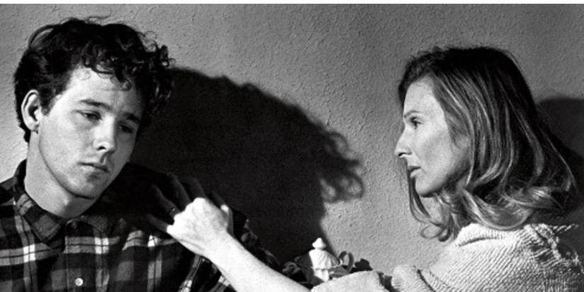 Timothy Bottoms and Cloris Leachman as Sonny and Ruth sitting and grabbing Sonny's shirt in 'The Last Picture Show'