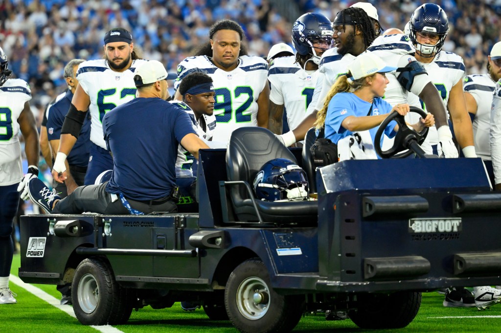 Seattle Seahawks safety Bud Clark (9) is carted off the field by medical staff.