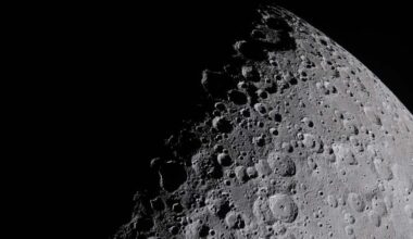 A photopgraph of the moon, taken at close range. Shadow obscures part of its face, highlighting crater edges.
