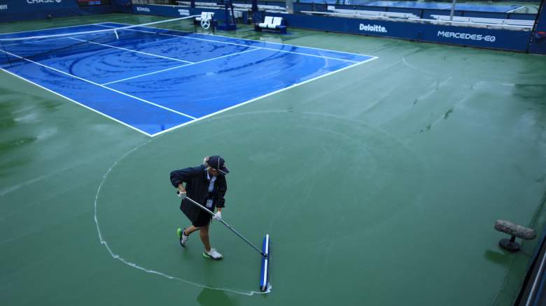 Court staff clean the rain off the courts at the USTA Billie Jean King National Tennis Center in New York