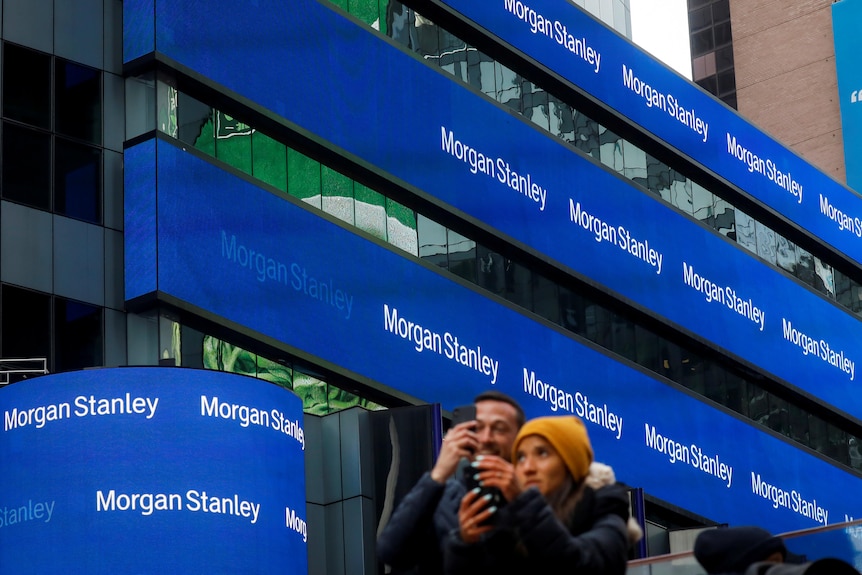 A series of billboards attached to a large building, reading 'Morgan Stanley'.