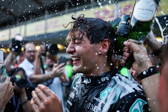 Race winner George Russell celebrates his victory with the Mercedes team.