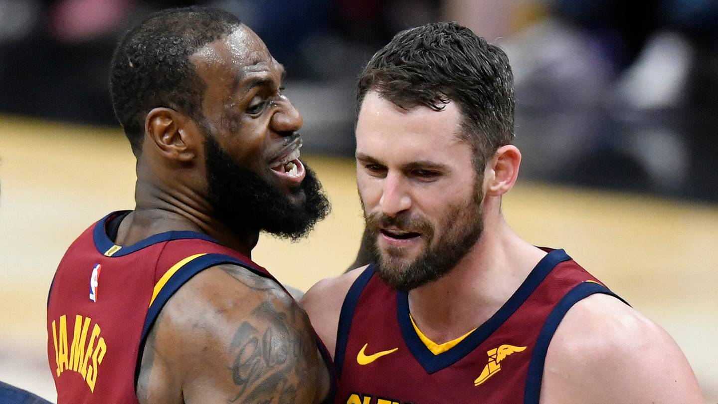Cleveland Cavaliers center Kevin Love (0) celebrates his three-point basket with forward LeBron James (23) in the fourth quarter against the Toronto Raptors at Quicken Loans Arena.
