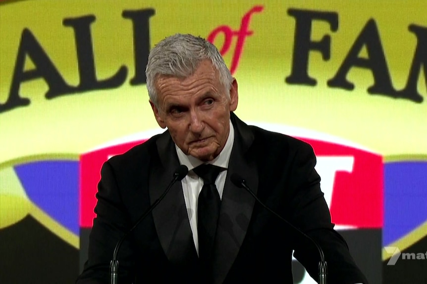 A man speaks at a lectern