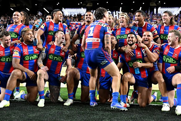 Kalyn Ponga (centre, back to camera) celebrates Newcastle’s upset win over North Queensland in Las Vegas with his Knights teammates.