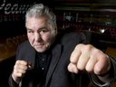 Former Canadian heavyweight boxer George Chuvalo mugs for a photo inside Peanuts Pub in the Carriage House Inn in Calgary, Alta., on Monday, April 18, 2016. Chuvalo died on Saturday, Sept. 12, 2026, at the age of 89. 