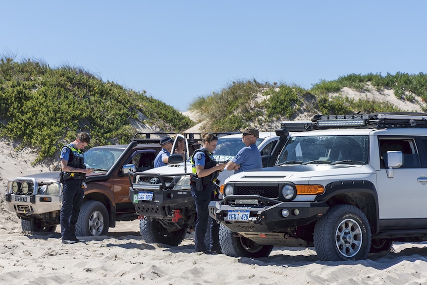 Police speak to witnesses on the beach