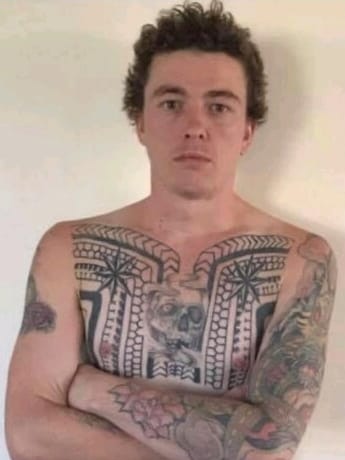 Man staring at camera with his arms crossed.